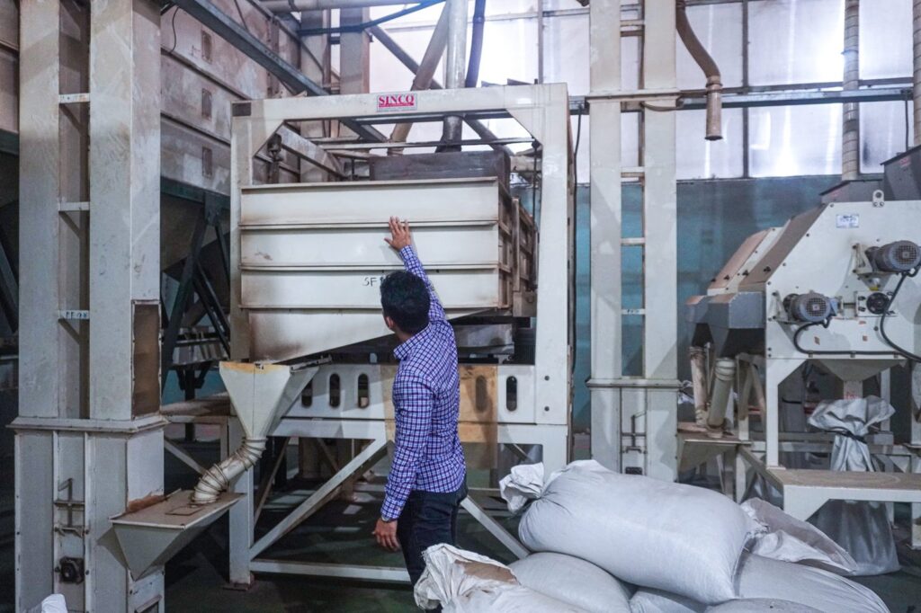 Liam Phan checking a pepper cleaning machine