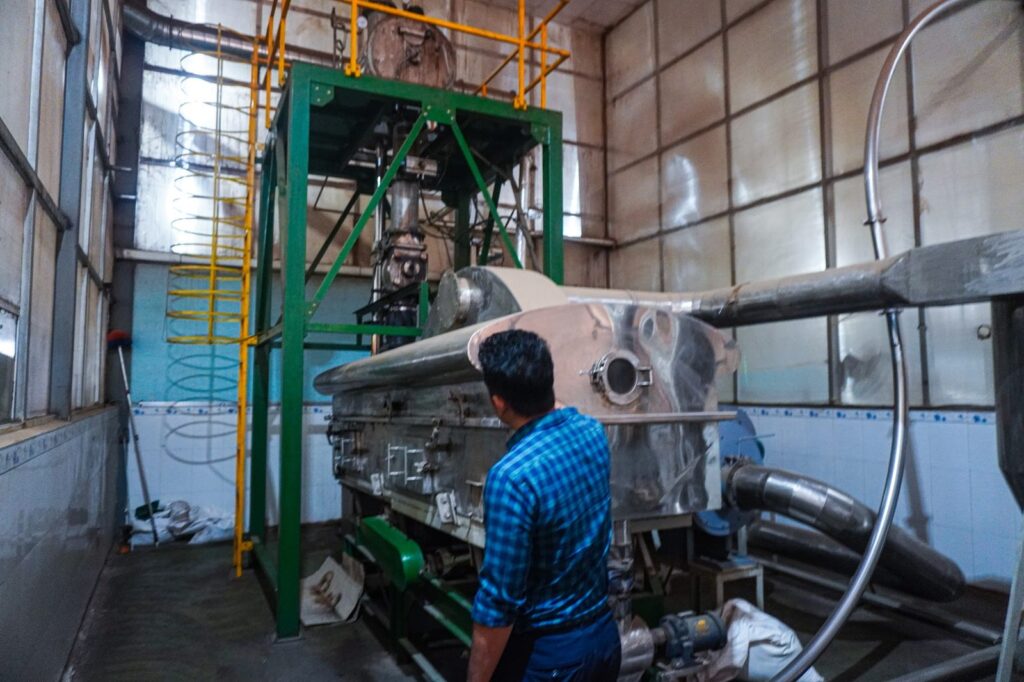 Liam Phan at a pepper processing machine